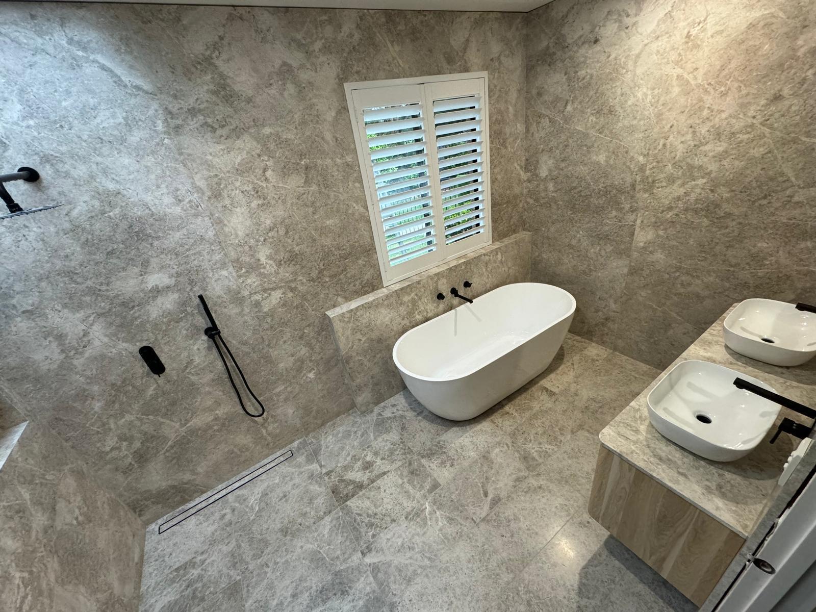 Built In project - Stone bathroom with freestanding bath and twin vanities